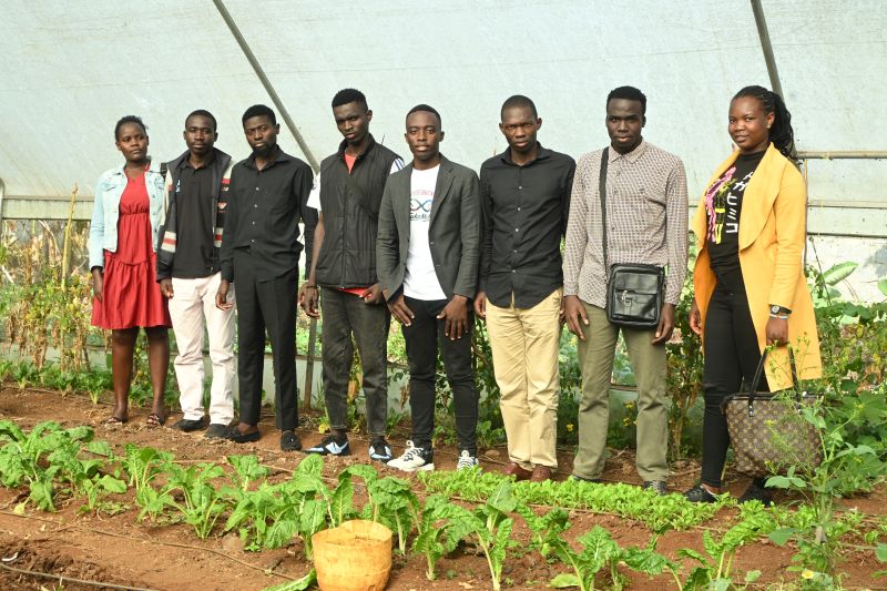 Extension officers and farmers at a greenhouse
