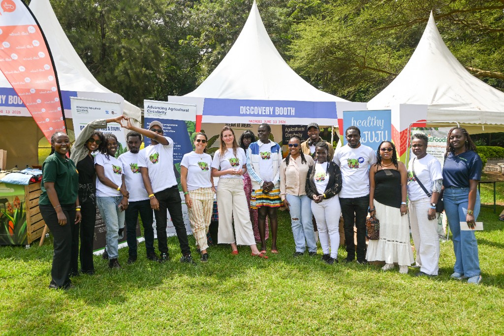 AAC team and partners posing in front of the Discovery Booth tents