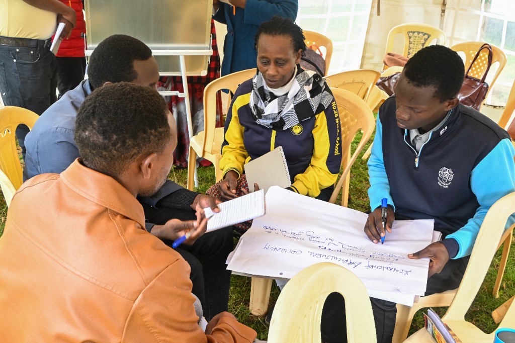 Four participants writing Advancing Agricultural Circularity notes during a workshop